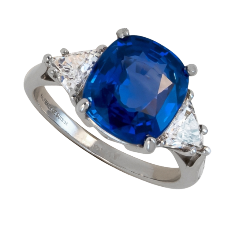 22882 Classic Three Stone Sapphire & Diamond Ring Designed and Handmade by Kaufmann de Suisse in Platinum featuring one Cushion Cut 4.87cts Blue Sapphire flanked by two HVS Quality Triangle Diamon